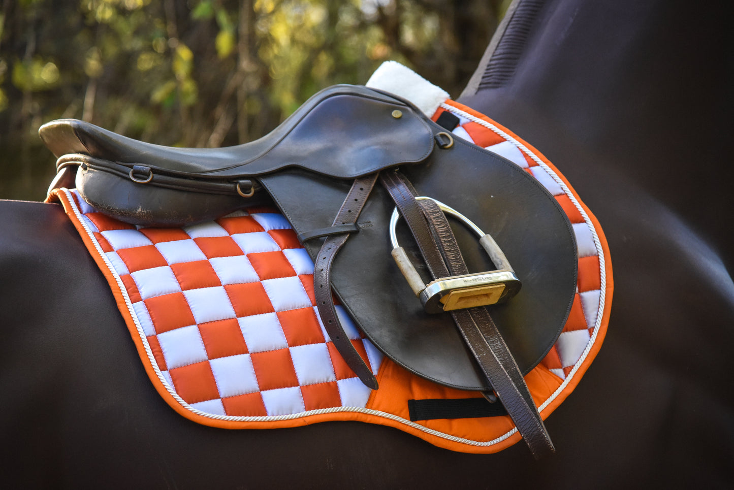 Orange/white checker saddle pad