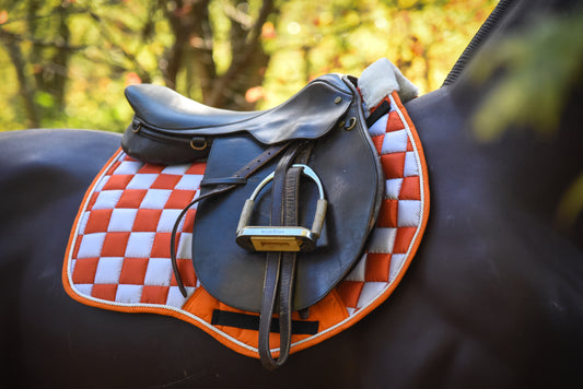 Orange/white checker saddle pad